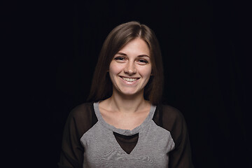 Image showing Close up portrait of young woman isolated on black studio background