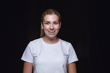 Image showing Close up portrait of young woman isolated on black studio background