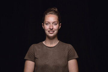 Image showing Close up portrait of young woman isolated on black studio background