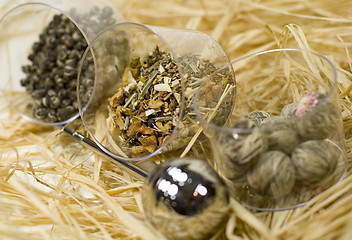 Image showing  tea-strainer and tree kinds of tea