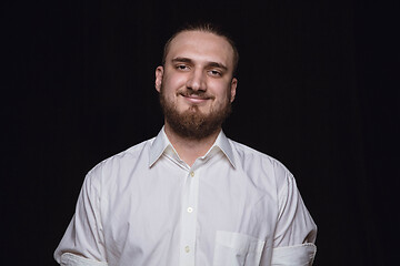 Image showing Close up portrait of young man isolated on black studio background