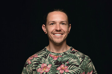 Image showing Close up portrait of young man isolated on black studio background