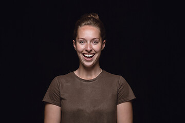 Image showing Close up portrait of young woman isolated on black studio background