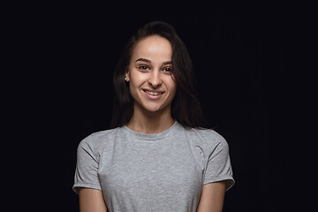 Image showing Close up portrait of young woman isolated on black studio background