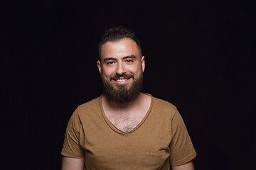 Image showing Close up portrait of young man isolated on black studio background