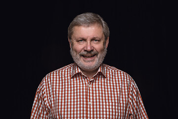 Image showing Close up portrait of senior man isolated on black studio background