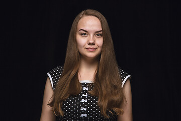 Image showing Close up portrait of young woman isolated on black studio background