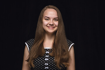 Image showing Close up portrait of young woman isolated on black studio background