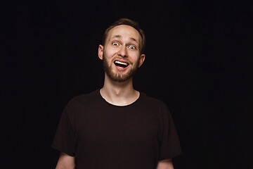 Image showing Close up portrait of young man isolated on black studio background