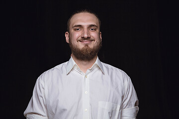 Image showing Close up portrait of young man isolated on black studio background