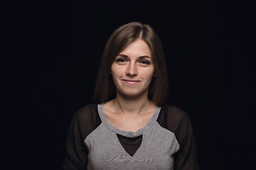 Image showing Close up portrait of young woman isolated on black studio background