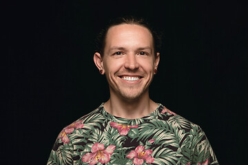 Image showing Close up portrait of young man isolated on black studio background