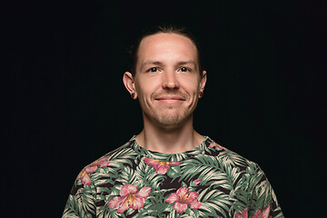 Image showing Close up portrait of young man isolated on black studio background