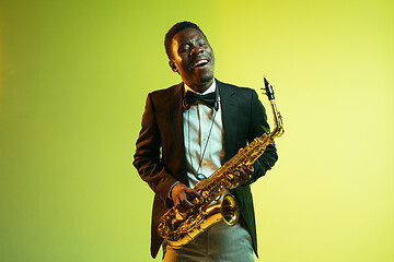 Image showing Young african-american jazz musician playing the saxophone