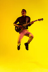 Image showing Young african-american jazz musician playing the guitar