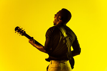 Image showing Young african-american jazz musician playing the guitar