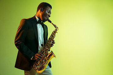 Image showing Young african-american jazz musician playing the saxophone