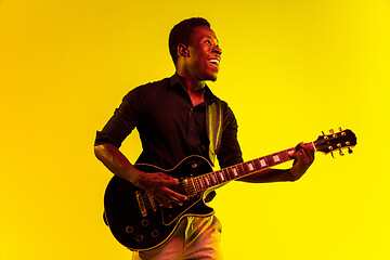 Image showing Young african-american jazz musician playing the guitar