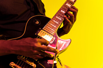 Image showing Young african-american jazz musician playing the guitar