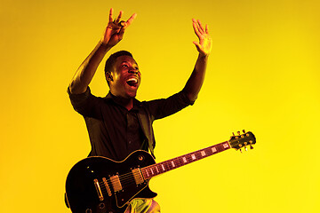 Image showing Young african-american jazz musician playing the guitar