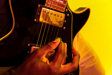 Image showing Young african-american jazz musician playing the guitar