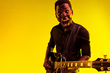 Image showing Young african-american jazz musician playing the guitar