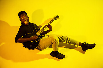 Image showing Young african-american jazz musician playing the guitar