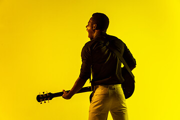 Image showing Young african-american jazz musician playing the guitar