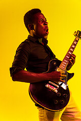 Image showing Young african-american jazz musician playing the guitar