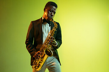 Image showing Young african-american jazz musician playing the saxophone