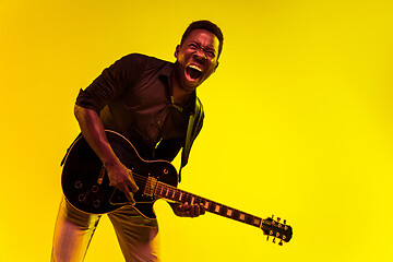 Image showing Young african-american jazz musician playing the guitar