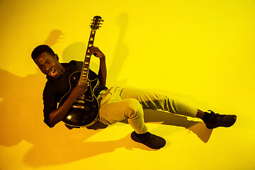 Image showing Young african-american jazz musician playing the guitar