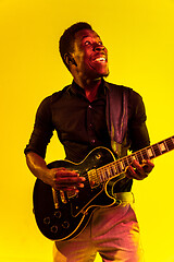 Image showing Young african-american jazz musician playing the guitar