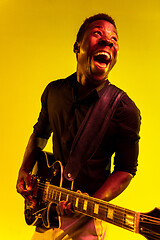 Image showing Young african-american jazz musician playing the guitar