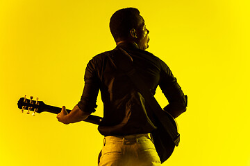 Image showing Young african-american jazz musician playing the guitar