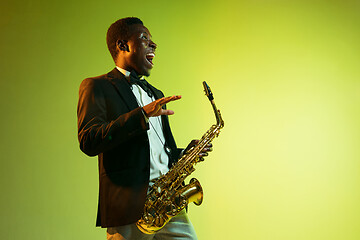 Image showing Young african-american jazz musician playing the saxophone