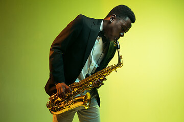 Image showing Young african-american jazz musician playing the saxophone