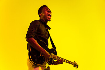 Image showing Young african-american jazz musician playing the guitar