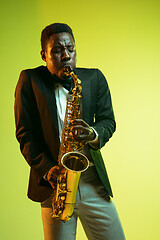 Image showing Young african-american jazz musician playing the saxophone