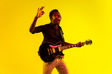 Image showing Young african-american jazz musician playing the guitar