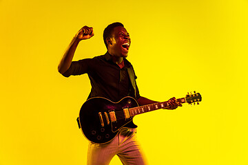 Image showing Young african-american jazz musician playing the guitar