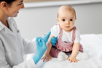 Image showing doctor making vaccine for baby patient at clinic