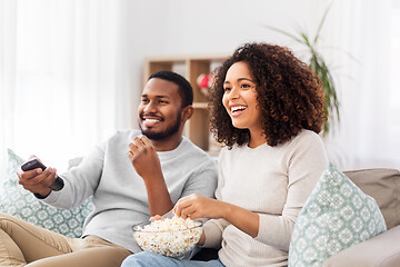 Image showing african couple with popcorn watching tv at home