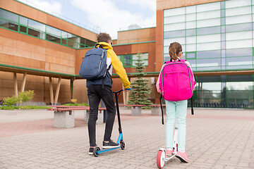 Image showing school children with backpacks and scooters