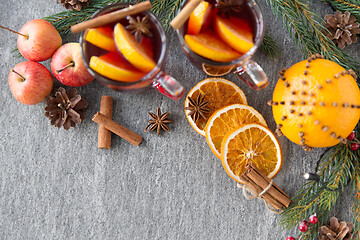 Image showing glass of hot mulled wine, cookies, apples and fir