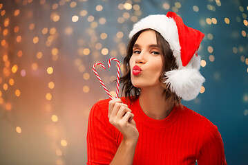 Image showing happy young woman in santa hat on christmas