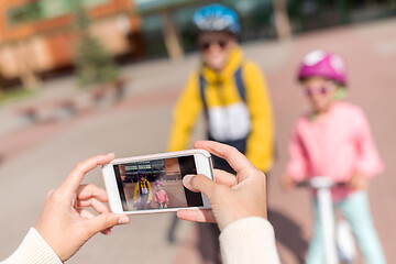 Image showing hands with smartphone photographing school kids