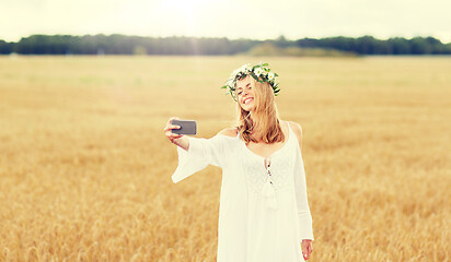 Image showing happy young woman taking selfie by smartphone