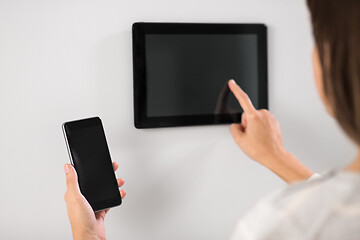 Image showing woman using tablet computer and smartphone