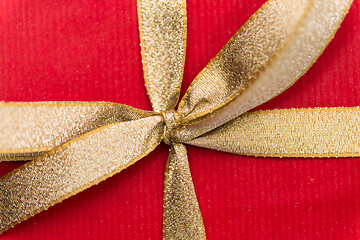 Image showing close up of christmas red gift box with golden bow